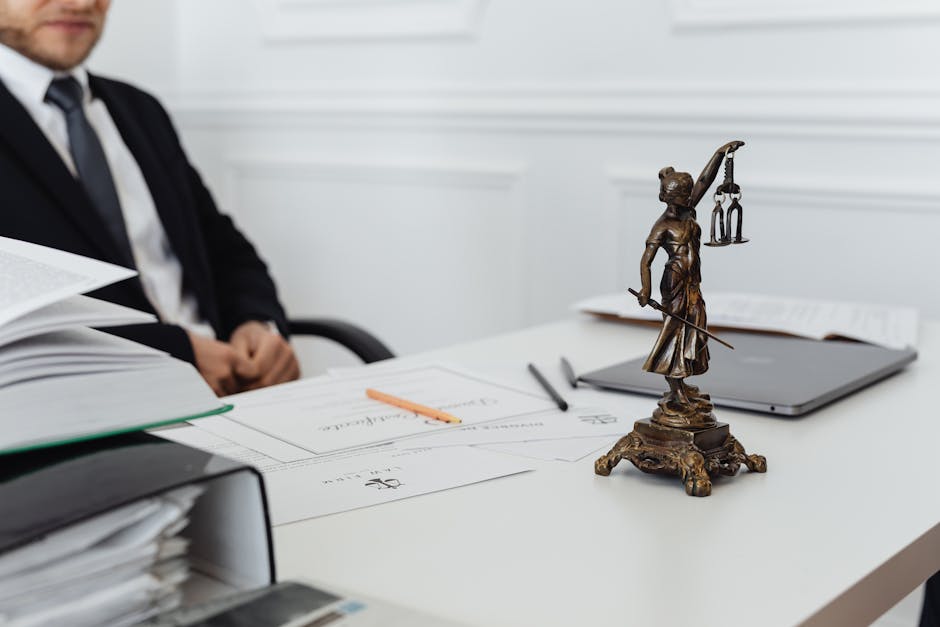 Mesothelioma lawyer file review: a close-up of a stack of legal documents, medical records, and a yellow legal pad on a wooden desk, the kind of paper file every mesothelioma lawyer assembles during the first 60 days of building an asbestos exposure case for trust and trial recovery