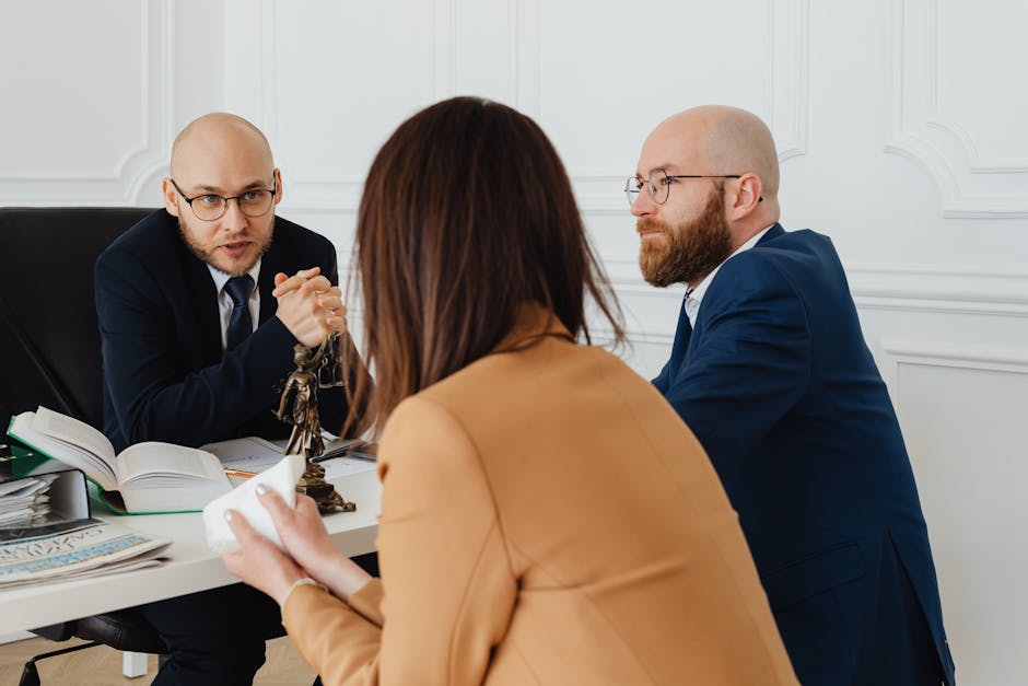 Mesothelioma lawyer firm interview: a group of attorneys in suits seated around a polished conference table reviewing case files in a modern law office, the kind of working session where a mesothelioma lawyer team builds the trust-claim package alongside the trial-track strategy during the first 60 days of representation