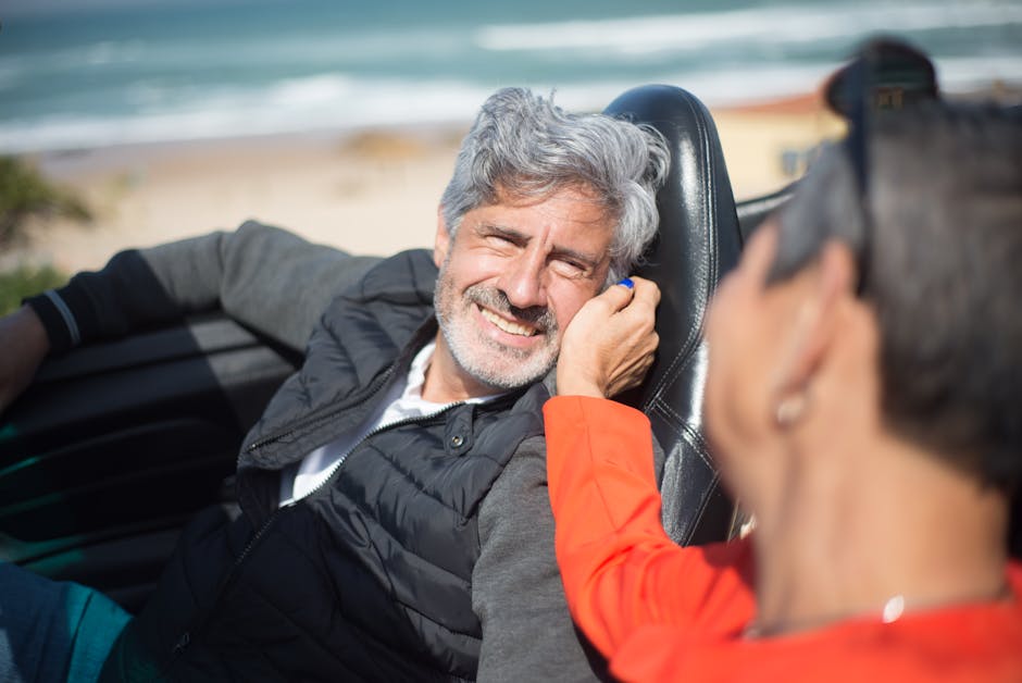 Best car insurance for seniors: smiling senior couple driving a convertible on a sunny coastal road, the kind of confident behind-the-wheel lifestyle the right best car insurance for seniors policy is built to protect